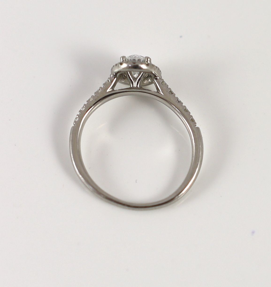 A modern platinum and single stone oval cut diamond set ring, with diamond setting and diamond set shoulders, with accompanying GIA report dated 13/8/2019, stating that the oval brilliant cut diamond to weigh 0.70ct with